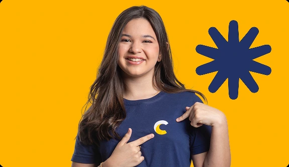 Aluna do Contemporâneo sorrindo, em frente a fundo amarelo com grafismo de asterisco